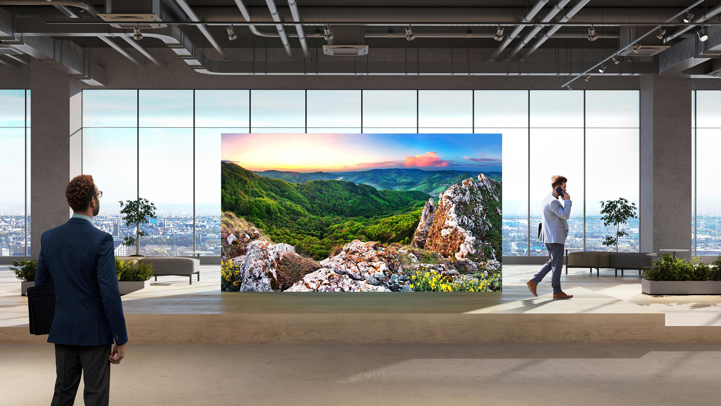 A Sony video wall displaying a panoramic nature scene with lush greenery and rocky landscapes in a modern setting.
